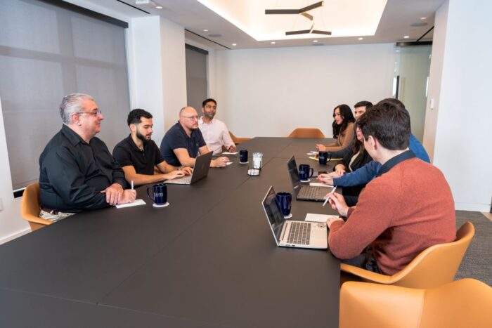 Axias team meeting in conference room for cost estimating